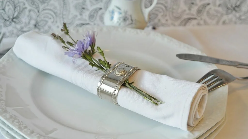 a cloth napkin with a silver napkin ring