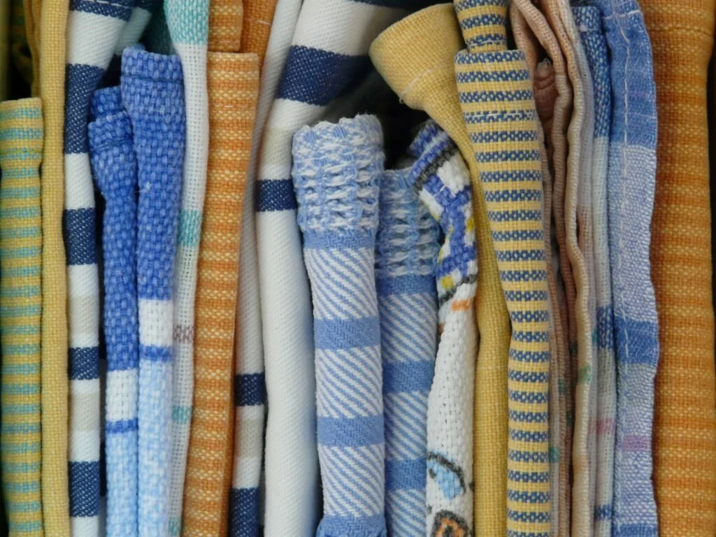 a stack of dishtowels in different colors