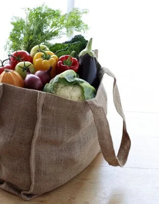 a reusable linen shopping bag filled with vegetables